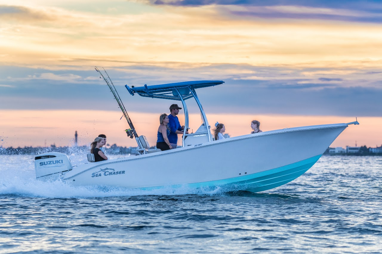 a speedboat sailing in the sea with several people on it